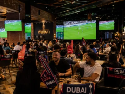 Football supporters watching a match in a Dubai sports bar